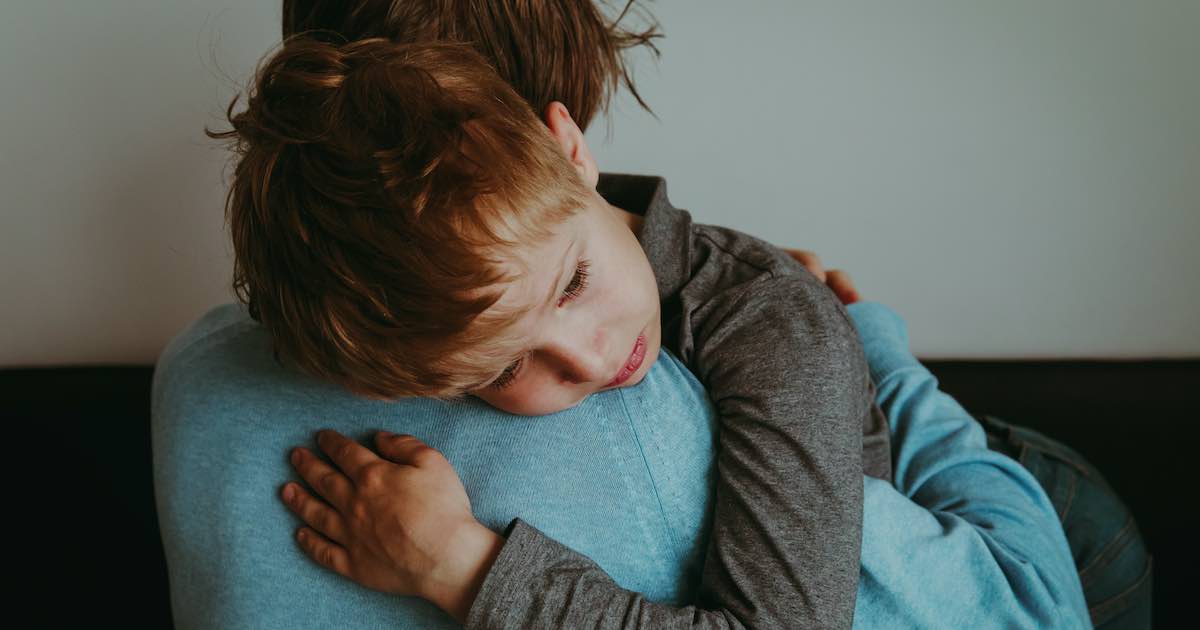 Father comforting sad child